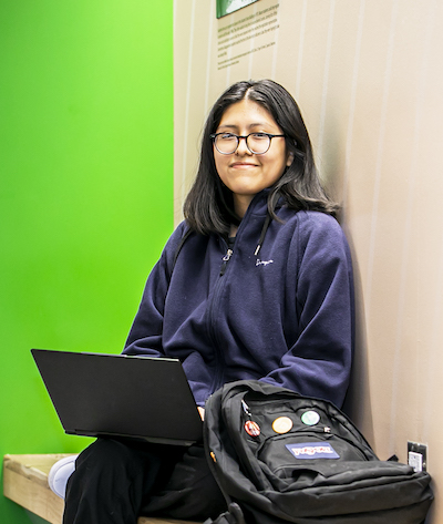 young woman sitting with laptop