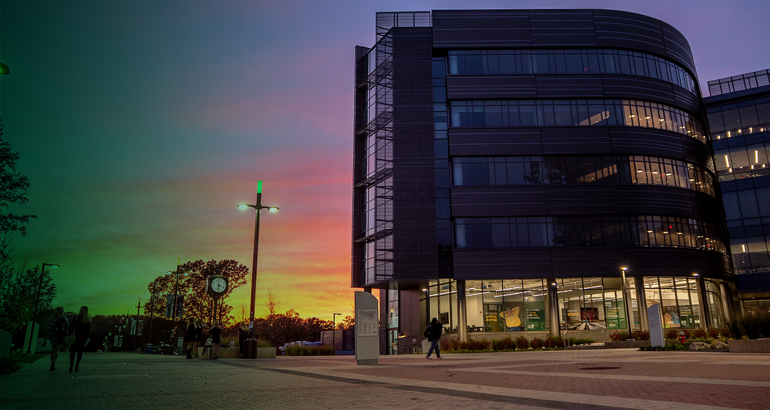 A beautiful sunset is visible over Wilkins Plaza in the Fairfax Campus.