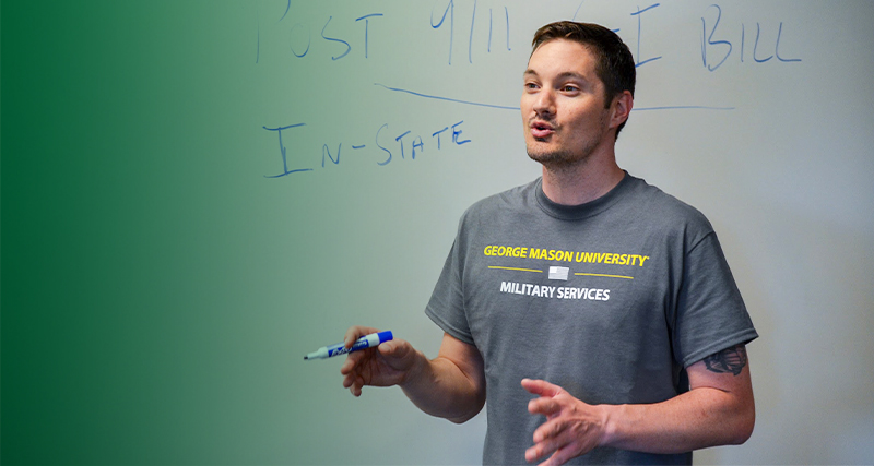 A Mason student from the Office of Military Services presents while standing in front of a whiteboard.