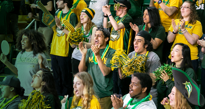 Mason students cheer in excitement at the Homecoming basketball game.