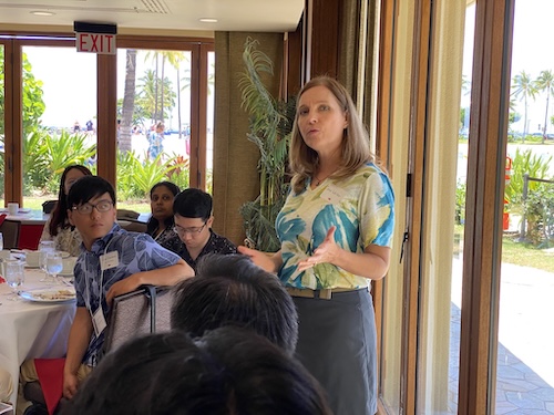 Jane Walker speaking and standing in a room of seated students