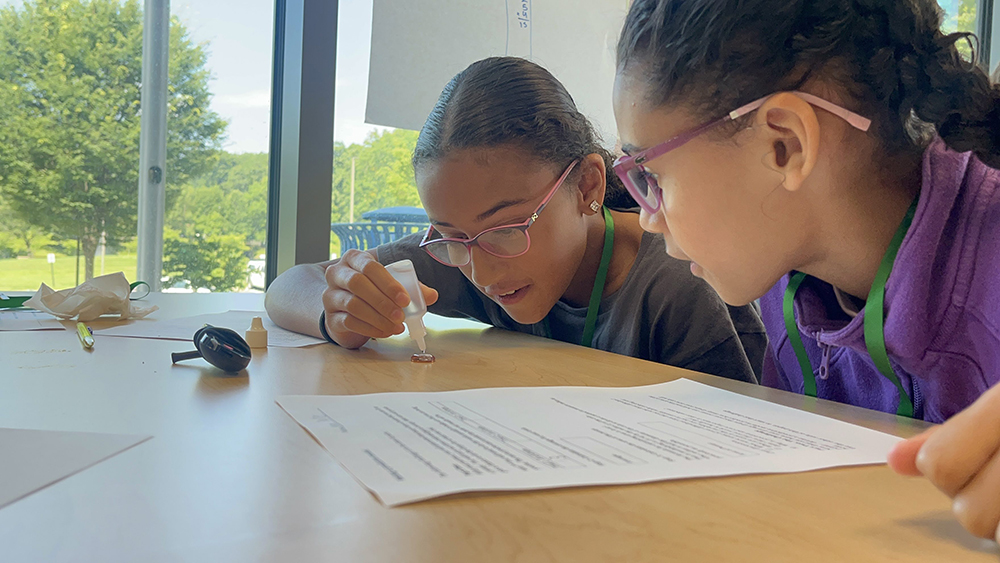 young students collaborate on a worksheet