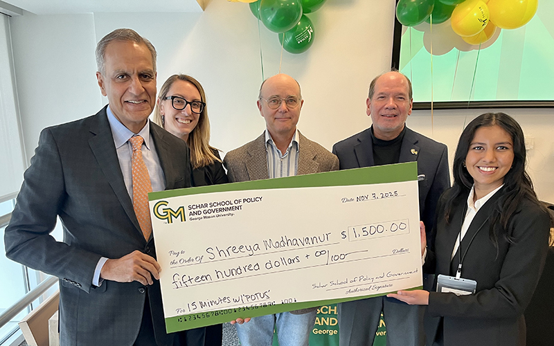 Winner receiving ceremonial check (group photo with large check)