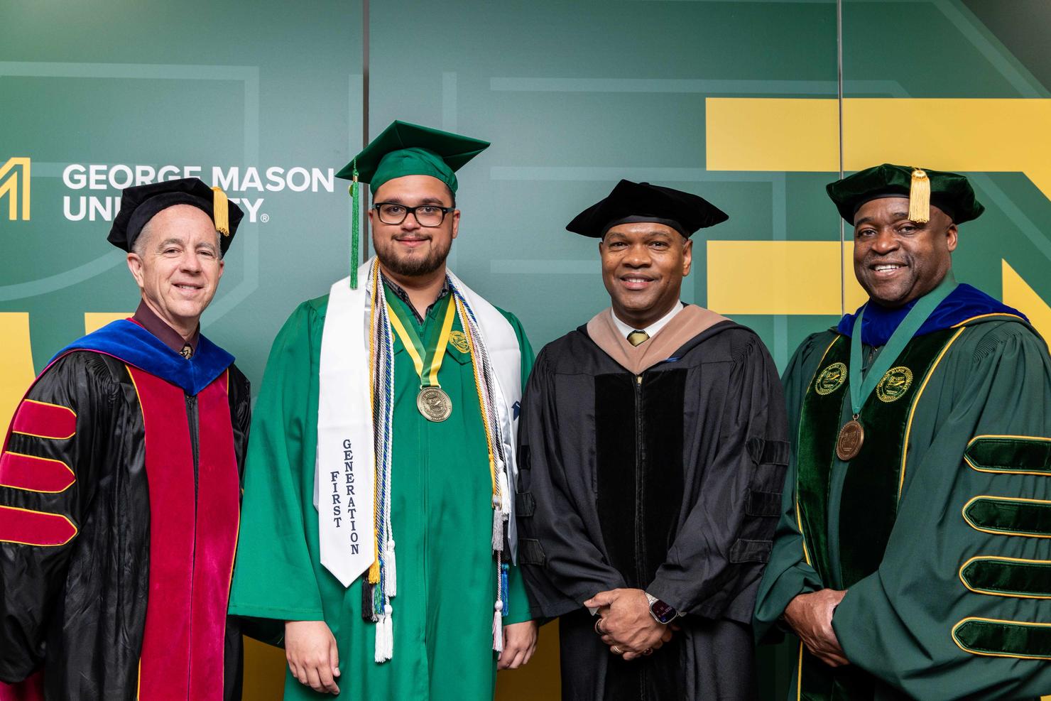 George Mason Provost, student Commencement speaker, Rector, and President stand together and smile