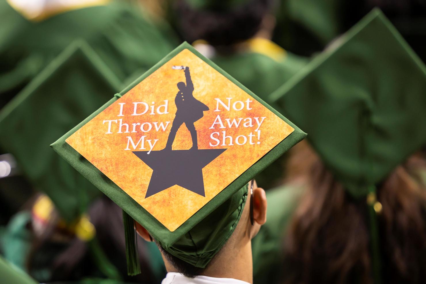 Decorated cap has imagery from Hamilton the musical and says "I did not throw away from shot!"