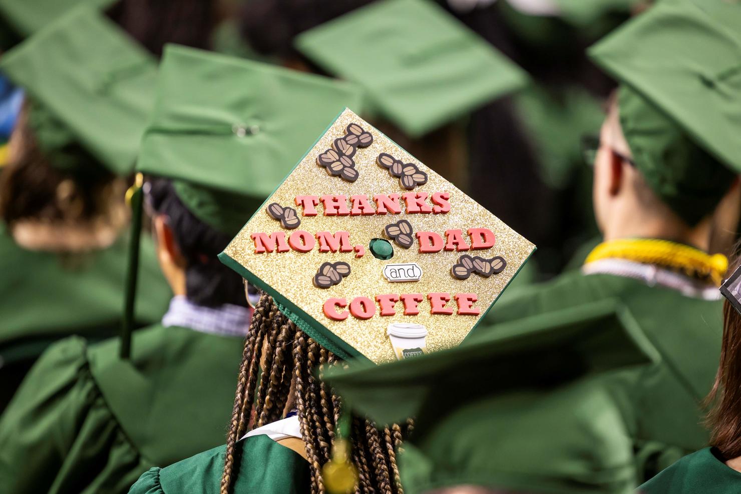 Decorated cap says "Thanks Mom, Dad, and Coffee"