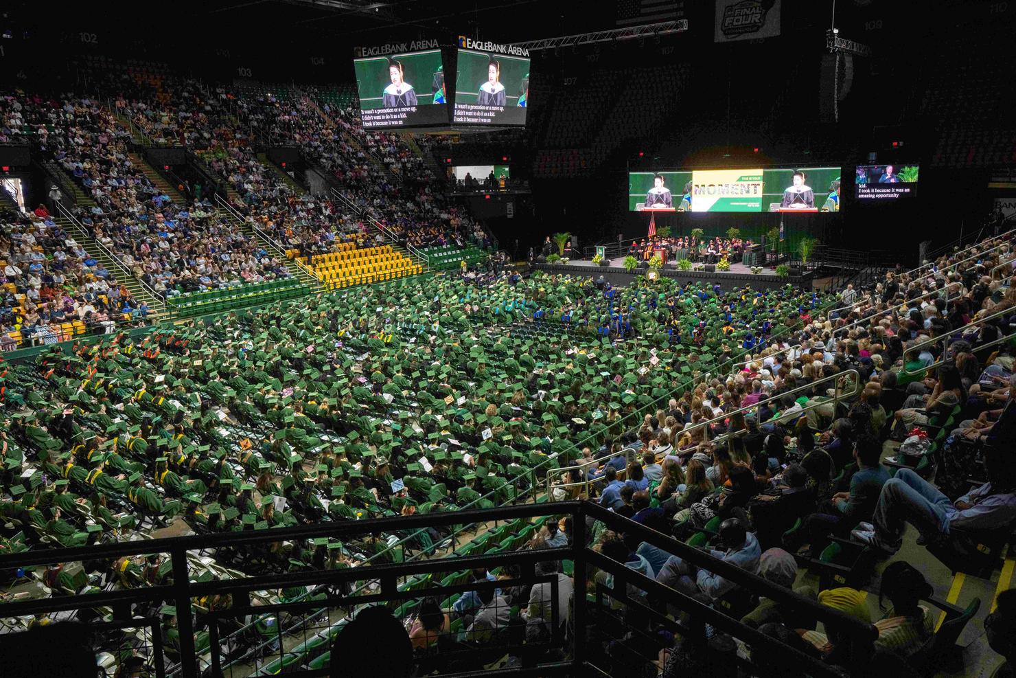 Bird's eye view of EagleBank Arena filled with graduates on the floor, and the stands are packed with attendees