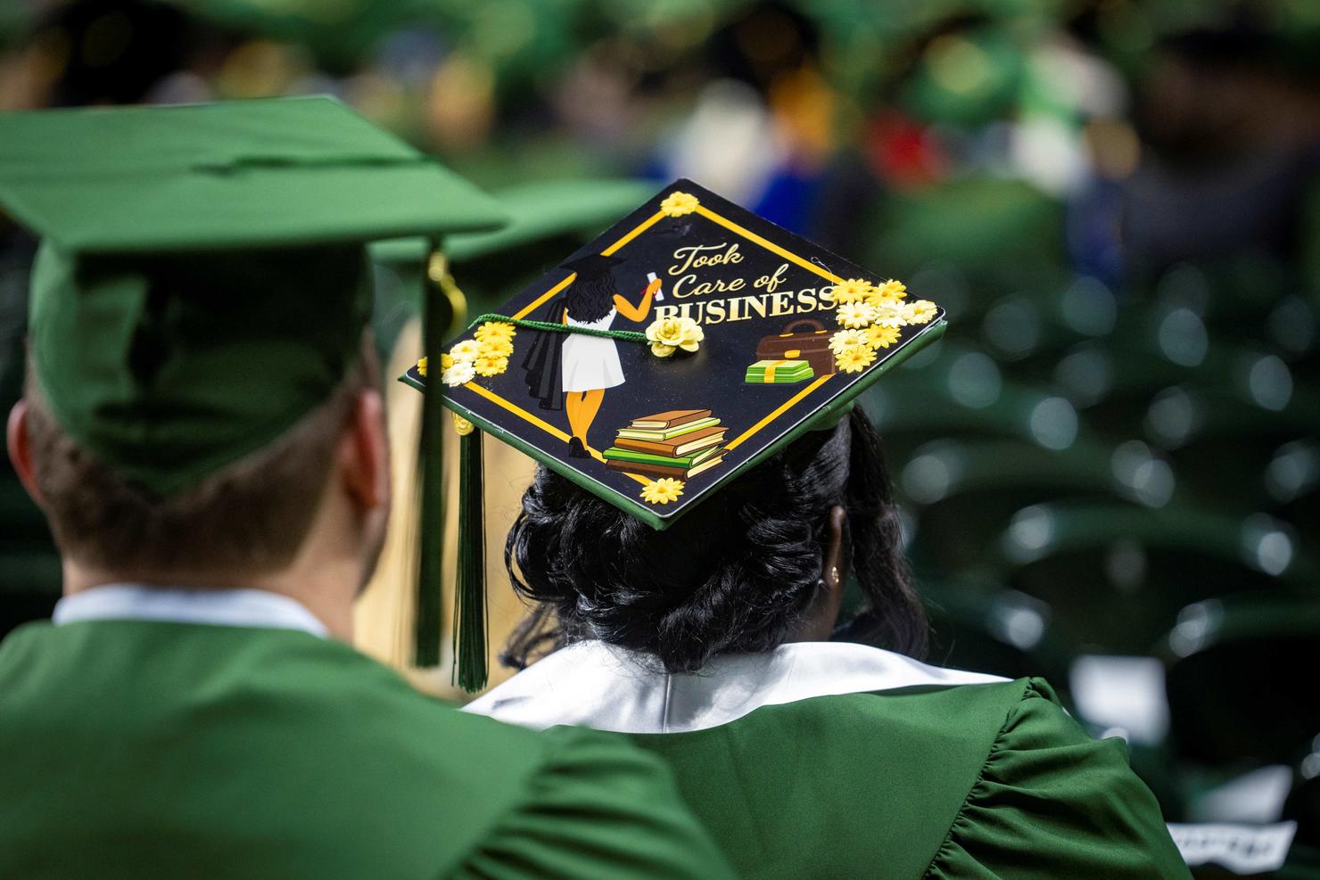 Graduate wears a decorated cap that says Took Care of Business