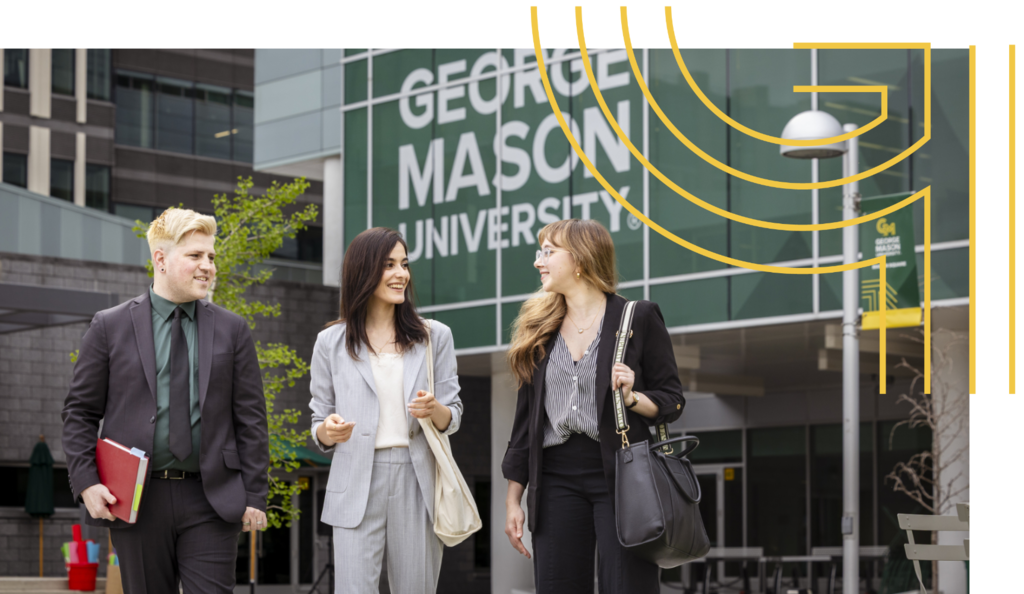 Three students in professional attire walk outside a building with George Mason University window clings.