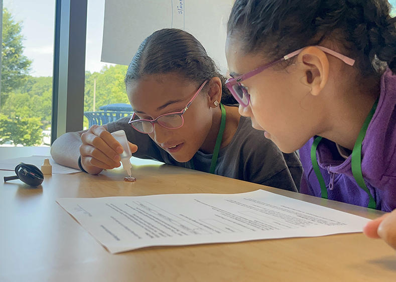 Two young students work together on a project