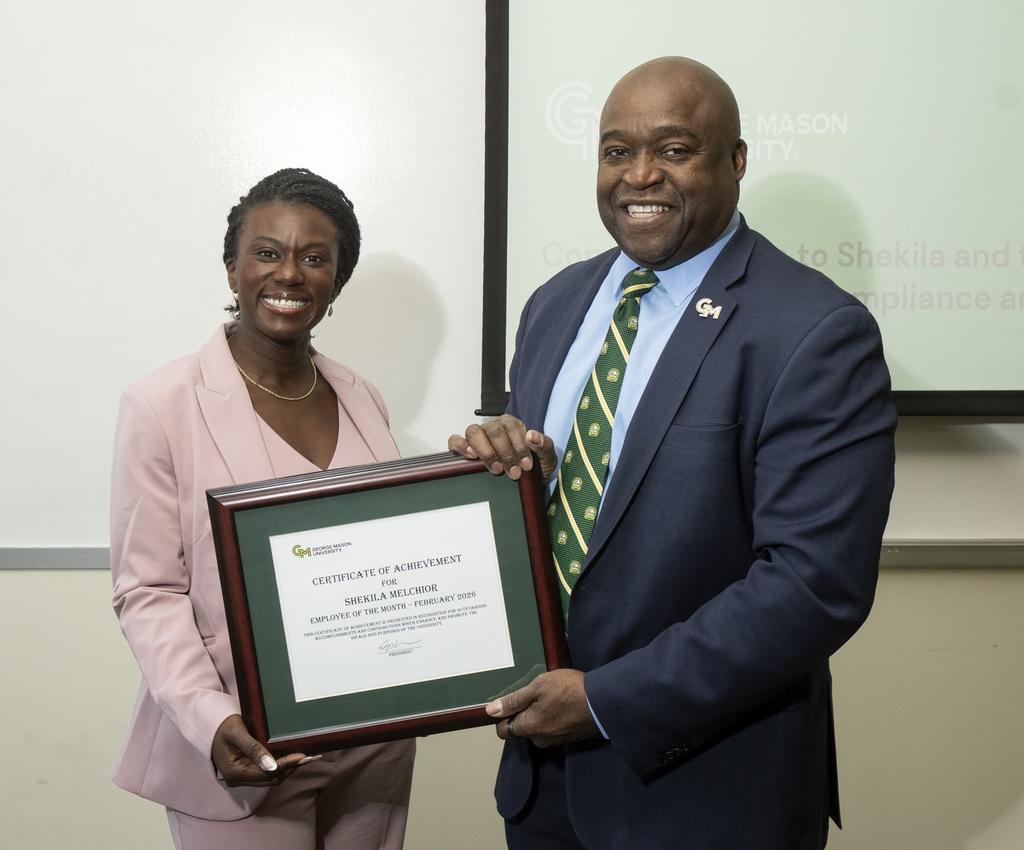 Employee of the Month Shekila Melchior and President Gregory Washington hold her certificate together
