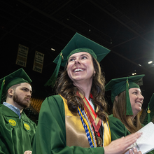 Graduates applauding at commencement ceremony