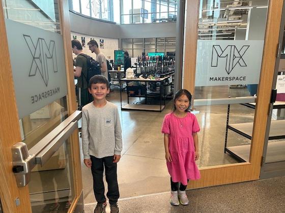 Two children stand together at the entrance to The Mix
