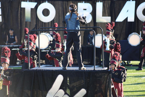 A student drum major directs the Oakton High School marching band during their performance of Parade to Black.