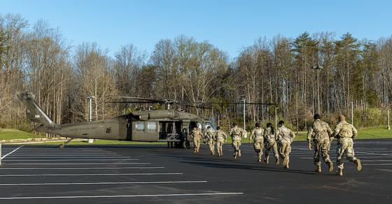 ROTC running towards a Black Hawk UH-60 helicopter