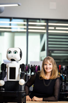 Missy Cummings is shown next to a robot