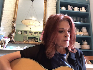 Rosanne Cash playing guitar.