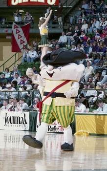 Former Mason mascot Gunston, a human-like character wearing a tricorner hat and Colonial-era garb, on the basketball court