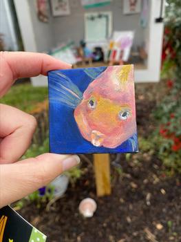 A miniature piece of artwork, a painting of a fish